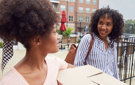 two women chatting outside rental home