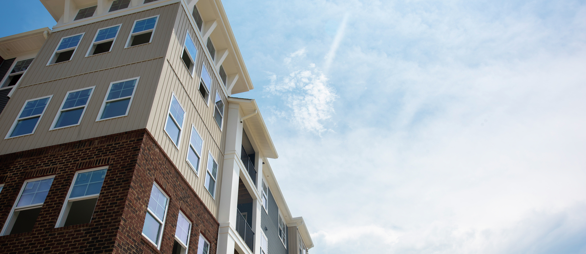 Multifamily-Apartment-Building-Sky-Clouds-GettyImages-1163226282.jpg