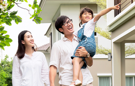 Asian family taking a walk outside on a suburban street