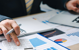close up of hands in a suit reviewing numbers