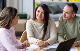 A hispanic couple works with a lender who meets their needs