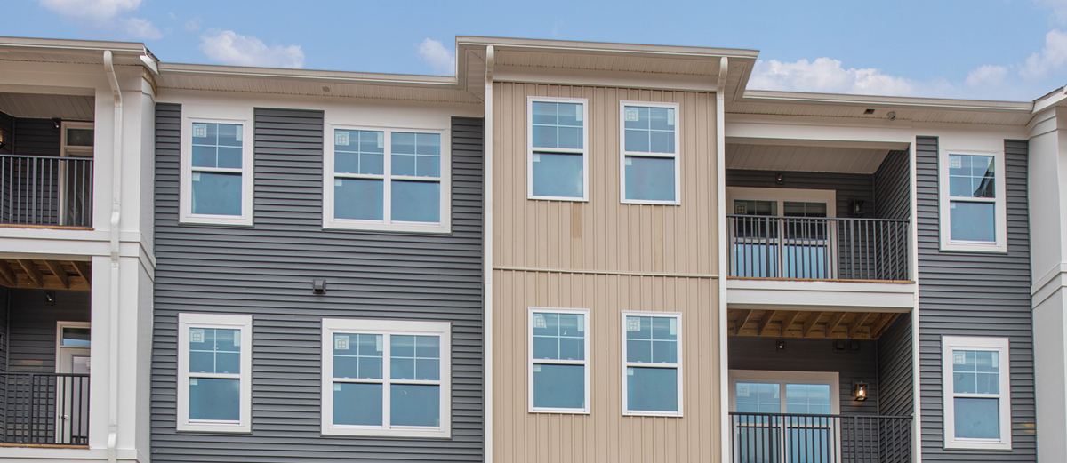 Multifamily-Apartment-Building-Blue-Sky-GettyImages-1210157146.jpg