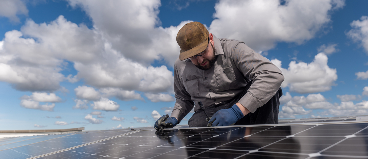 Solar Panel worker on the roof - stock image