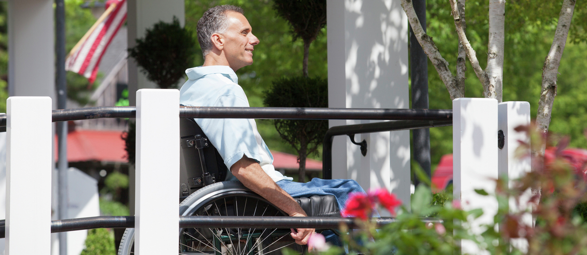 Accessibility-Wheelchair-Man-Smiling-Porch-Flag-153998350.jpg